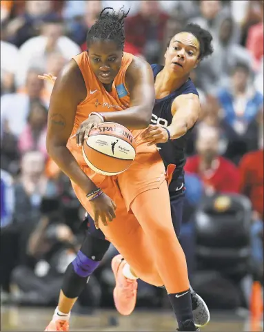  ?? Jessica Hill / Associated Press ?? Shekinna Stricklen, front, of the Sun escapes the defense of the Mystics' Kristi Toliver during the first half of Tuesday night’s Game 4 of the WNBA Finals in Uncasville.