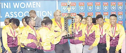  ?? ?? Young Buffaloes Ladies celebratin­g after receiving the trophy as they were officially crowned champions of the 2021/22 Women’s Football League during the event held at Sigwaca House in Mbabane. (BELOW) The seven Player of the Month Award winners with their trophies.