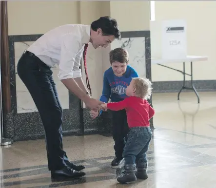  ?? NICHOLAS KAMM/ AFP/ GETTY IMAGES ?? Liberal Party Leader Justin Trudeau waits with his sons Hadrien, right, and Xavier to cast his ballot in Montreal Monday. Trudeau emerged victorious after a campaign that should have finally silenced his doubters.