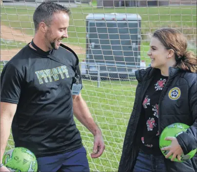  ?? JASON SIMMONDS/JOURNAL PIONEER ?? Three Oaks Axewomen fullback Georgie McKenna and athletic director Joel Arsenault share a laugh as they discuss the Playtex Play On grant program. McKenna’s nomination was selected, and the Three Oaks senior AAA girls’ soccer team received one of 10...