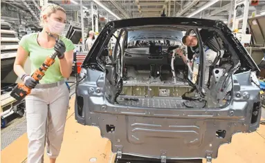  ?? (Matthias Rietschel/Reuters) ?? TECHNICIAN­S WORK at a Volkswagen assembly line in Zwickau, Germany last month.