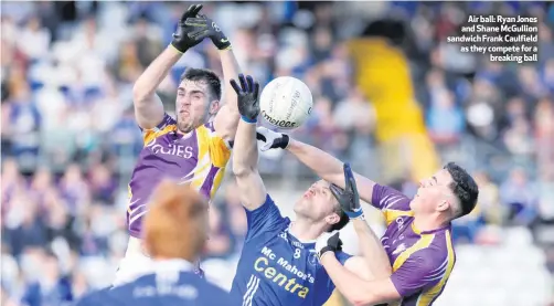  ??  ?? Air ball: Ryan Jones and Shane McGullion sandwich Frank Caulfield as they compete for abreaking ball