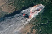  ?? Photo courtesy NASA ?? This photo taken from a NASA satellite shows the Camp Fire after it erupted 90 miles north of Sacramento, California. One day after it began, the blaze consumed the town of Paradise and had grown to nearly 110 square miles and was burning completely out of control.