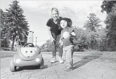  ?? BARRY GRAY THE HAMILTON SPECTATOR ?? Kyla Makela and toddler son Warren play on the Pipeline Trail, which runs past their home on Park Row North. Kyla and her husband moved to Hamilton from Toronto recently and chose the home they bought in part because of its proximity to the trail.