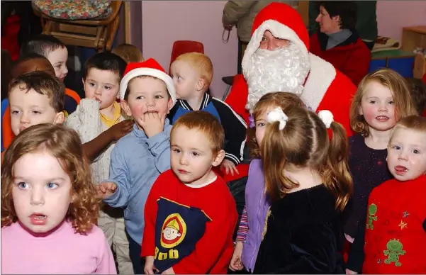  ??  ?? All Smiles......Children from the Holy Family Creche with Santa during his visit to the Holy Family Community Creche.