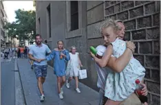  ?? GIANNIS PAPANIKOS ?? AP PHOTO BY People flee the scene in Barcelona, Spain, Thursday, after a white van jumped the sidewalk in the historic Las Ramblas district, crashing into a summer crowd of residents and tourists and injuring several people, police said.