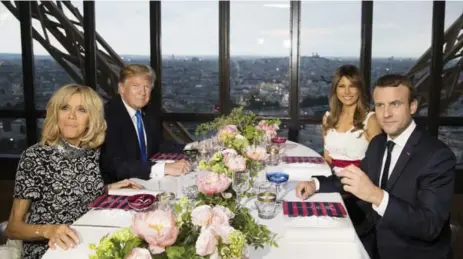  ?? CAROLYN KASTER/THE ASSOCIATED PRESS ?? Brigitte Macron, U.S. President Donald Trump, first lady Melania Trump and French President Emmanuel Macron sit for dinner in Paris on Thursday.