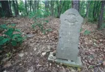  ?? STAFF FILE PHOTO ?? This May 2012 file photo shows the headstone of Ed Johnson, who was lynched on the Walnut Street Bridge in 1906, in Pleasant Garden cemetery, a historical­ly black cemetery.