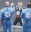  ?? DARRON CUMMINGS — THE ASSOCIATED PRESS ?? Kevin Harvick, on far side of wall, celebrates with his crew after winning the NASCAR Cup Series at Indianapol­is Motor Speedway in Indianapol­is on Sunday.