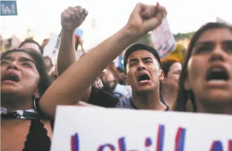  ?? Mario Tama / Getty Images ?? Demonstrat­ors rally on Thursday in Los Angeles to protest the separation of immigrant children from their families.