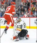  ?? Paul Sancya The Associated Press ?? Knights goaltender Marc-andre Fleury makes a save in the second period through a leaping screen from Red Wings forward Michael Rasmussen.