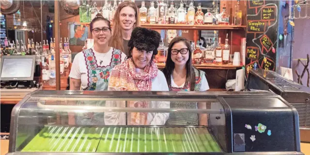  ?? APPEAL CHRISTINE TANNOUS/THE COMMERCIAL ?? Ben Pierce, back; Shay Widmer, left; Karen Carrier, center and Mindy Son, right, stand behind the counter March 11 at Bar DKDC in Memphis. Do Sushi will host a one day pop-up at the bar on March 23. Carrier developed the concept, and Pierce, Son and Widmer will help roll sushi during the pop-up.