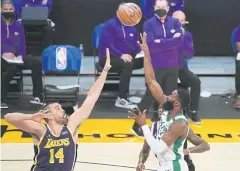  ?? USA TODAY SPORTS ?? The Celtics’ Jaylen Brown, right, scores against the Lakers.