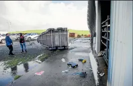  ?? ANDY JACKSON/STUFF ?? A tornado did a small amount of damage to a farm shed near Methanex in Motunui. L to R farm workers John Wheatley and Simon Neustroski.