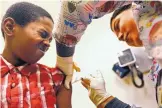  ?? GENARO MOLINA/LOS ANGELES TIMES ?? Desmond Sewell, 12, receives his vaccinatio­ns, including Tdap for pertussis, or whooping cough, from medical assistant Jessica Reyes at the Lou Colen Children’s Health and Wellness Center in Los Angeles.