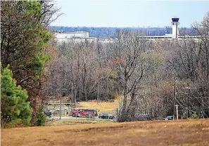  ?? Arkansas Democrat-Gazette/Staton Breidentha­l ?? Emergency vehicles appear near the location where a small aircraft crashed while taking off from the Bill and Hillary Clinton National Airport in Little Rock on Wednesday.