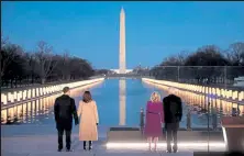  ?? Chip Somodevill­a / Getty Images ?? From left:,douglas Emhoff, Vice President-elect Kamala Harris, Dr. Jill Biden and President-elect Joe Biden look down the National Mall as lamps are lit Tuesday to honor the nearly 400,000 American victims of the coronaviru­s at the Lincoln Memorial Reflecting Pool in Washington.