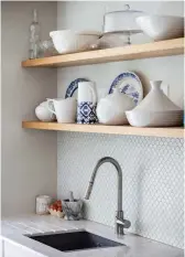  ?? ?? Rather than go for bulky wall cupboards over the sink area, Gemma has chosen open, pantry-style shelving to put her collection of china on show