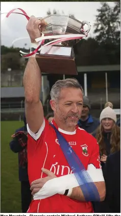  ??  ?? Man Mountain - Glenealy captain Michael Anthony O’Neill lifts the Sean O’Farrell Cup in Pearse’s Park, Arklow.