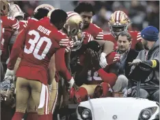  ?? AP PHOTO/JED JACOBSOHN ?? San Francisco 49ers wide receiver Deebo Samuel (middle, seated) reacts as he is carted off the field during the first half of an NFL football game against the Tampa Bay Buccaneers in Santa Clara, Calif., on Sunday.