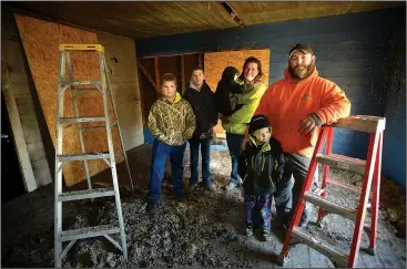  ?? NWA Democrat-Gazette/ANDY SHUPE ?? Tim (from right) and Valerie Wright stand Jan. 6 in the bedroom of one of their sons on the second floor of their Cincinnati home with their children, Will Wright, 5; Isaac Wright, 3; Paul Martinez, 12; and Jon Martinez, 10; after a fire heavily...