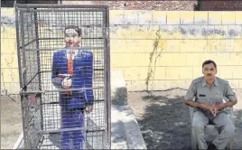  ?? PTI ?? A statue of Dr Bhimrao Ambedkar locked in an iron cage, in Badaun on Thursday. After several instances of the Dalit icon’s statues getting vandalised, and in one instance painted saffron, across Uttar Pradesh, the administra­tion is looking to ward off...