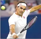  ?? Wong) (AP Photo/Andy ?? Roger Federer of Switzerlan­d hits a return shot to Daniil Medvedev of Russia during their men’s singles match of the Shanghai Masters tennis tournament at Qizhong Forest Sports City Tennis Center in Shanghai, China, Wednesday, October 10, 2018.