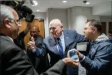  ?? ANDREW HARNIK — THE ASSOCIATED PRESS ?? Rudy Giuliani, center, an attorney for U.S. President Donald Trump, leaves after speaking at the Iran Freedom Convention for Human Rights and democracy at the Grand Hyatt, Saturday in Washington.