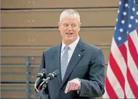  ?? STUART CAHILL / BOSTON HERALD ?? Gov. Charlie Baker gives his daily coronaviru­s update during a tour of the mass vaccinatio­n site at Reggie Lewis Arena at Roxbury Community College on Thursday.