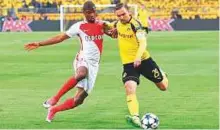  ?? Rex Features ?? Almamy Toure of Monaco (left) and Marcel Schmelzer of Dortmund in action during the Champions League quarter-final first leg tie in Dortmund last week.