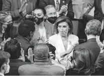  ?? Anna Moneymaker / Getty Images ?? Speaker Nancy Pelosi and House Democrats cheer the passage of the Build Back Better Act. Democrats must make the case to voters that the act has tangible benefits.