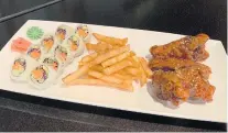  ?? SONJA BARISIC ?? The combo platter at Chick N Roll includes three fried chicken wings, a sushi roll and choice of french fries or coleslaw.
