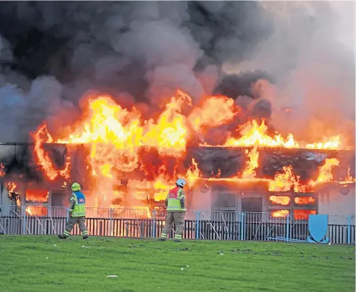  ?? Picture: David Wardle. ?? Firefighte­rs at the scene as the blaze rips through the school last night.