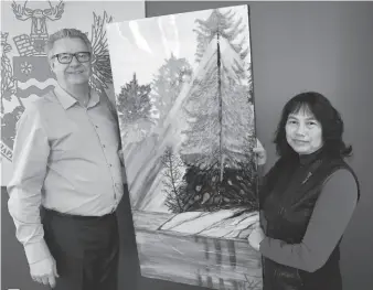  ?? CITIZEN PHOTO BY BRENT BRAATEN ?? Cat Valcourt, right, and Mayor Lyn Hall pose with a Valcourt painting that will be part of her art show on the fifth floor of city hall.