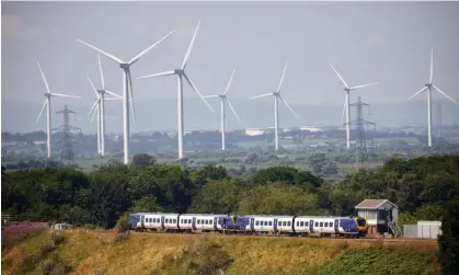  ?? Photograph: Mark Waugh/Alamy ?? The River Weaver viaduct at Frodsham, Cheshire with Frodsham wind farm in the background. There has been an informal ban on new wind farms since 2014.