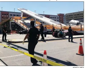  ?? AP/WTVJ NBC6 ?? Emergency crews work Thursday at the site of a collapsed pedestrian bridge at Florida Internatio­nal University in Miami.