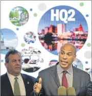  ?? SETH WENIG / AP ?? New Jersey Sen. Cory Booker (right) and New Jersey Gov. Chris Christie tout Newark as the best location for Amazon’s planned second headquarte­rs during an announceme­nt Monday. The economic benefits of the project seem clear, but may not be.