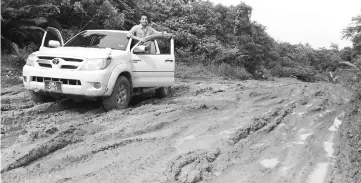  ??  ?? Dennis in a 4WD vehicle on one of the roads.