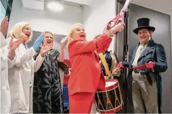  ?? Photos by Carlos Javier Sanchez/Contributo­r ?? Kathleen Gunn cuts the ribbon on a new laboratory named after her late husband at the Alamo. The facility will provide on-site care for more than 4,000 items in the Alamo’s possession.