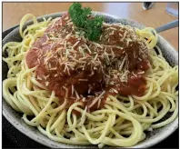  ?? Arkansas Democrat-Gazette/ERIC E. HARRISON ?? Al dente pasta, topped with coarse-ground meatballs and a rich marinara sauce, comprises the rave-worthy Spaghetti and Meatballs at Rocky’s on Country Club.