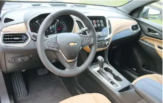  ??  ?? Like the Chevrolet Malibu, the dash of the Equinox 2.0T has clear and logically placed controls and major gauges.