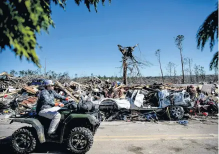  ?? DAVID GOLDMAN
AP ?? Debris sits on the side of a road in a neighborho­od devastated by a tornado in Beauregard, Ala., on Tuesday.•