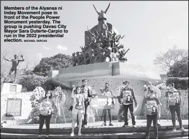  ?? MICHAEL VARCAS ?? Members of the Alyansa ni Inday Movement pose in front of the People Power Monument yesterday. The group is pushing Davao City Mayor Sara Duterte-Carpio to run in the 2022 presidenti­al election.