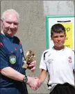  ??  ?? Arklow Town’s Shane Monaghan collects his Man of the Match award from referee Thomas ‘Tucker’ Dowling.