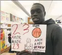  ?? David Borges / Hearst Connecticu­t Media ?? UConn’s Akok Akok shows off a drawing of himself made by a Naylor Elementary School student.