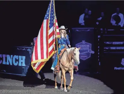  ?? PROVIDED BY GOVERNOR’S OFFICE ?? Governor Kristi Noem rides, with American flag in hand, into the Cinch Playoffs Governor’s Cup rodeo in Sioux Falls in September.