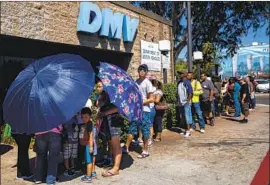  ?? Kent Nishimura Los Angeles Times ?? LONG DMV lines have been one hurdle for people trying to register for Real ID licenses, and now people may stay away from applying because of the coronaviru­s.