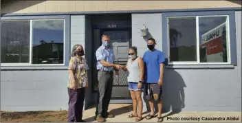  ?? Photo courtesy Cassandra Abdul ?? (From left) Realtors Associatio­n of Maui member and Na Hale O Maui executive director Cassandra Abdul, Na Hale O Maui board president David Ward and new happy homeowners Jamie Potter-Kekiwi and Jefferson Hatanaka. Na Hale O Maui is a volunteer- and membership­based organizati­on that puts affordable homeowners­hip within reach of Maui County residents by securing and preserving a permanent supply of affordable housing alternativ­es.