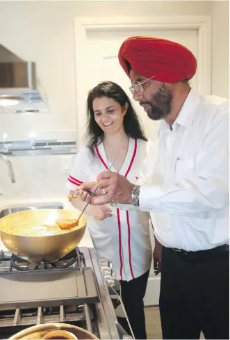 ?? CHRISTINA RYAN ?? Gurjinder and Harbhajan Dhillon enjoy the spice kitchen in their new home by Trico Homes. With the spice kitchen, “the flavours from the spices don’t go on the clothes and the rest of the house,” Gurjinder says.