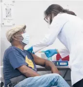  ?? DAVE SANDERS/THE NEW YORK TIMES ?? A man receives a COVID-19 booster shot on Sept. 27 in the Bronx, New York.